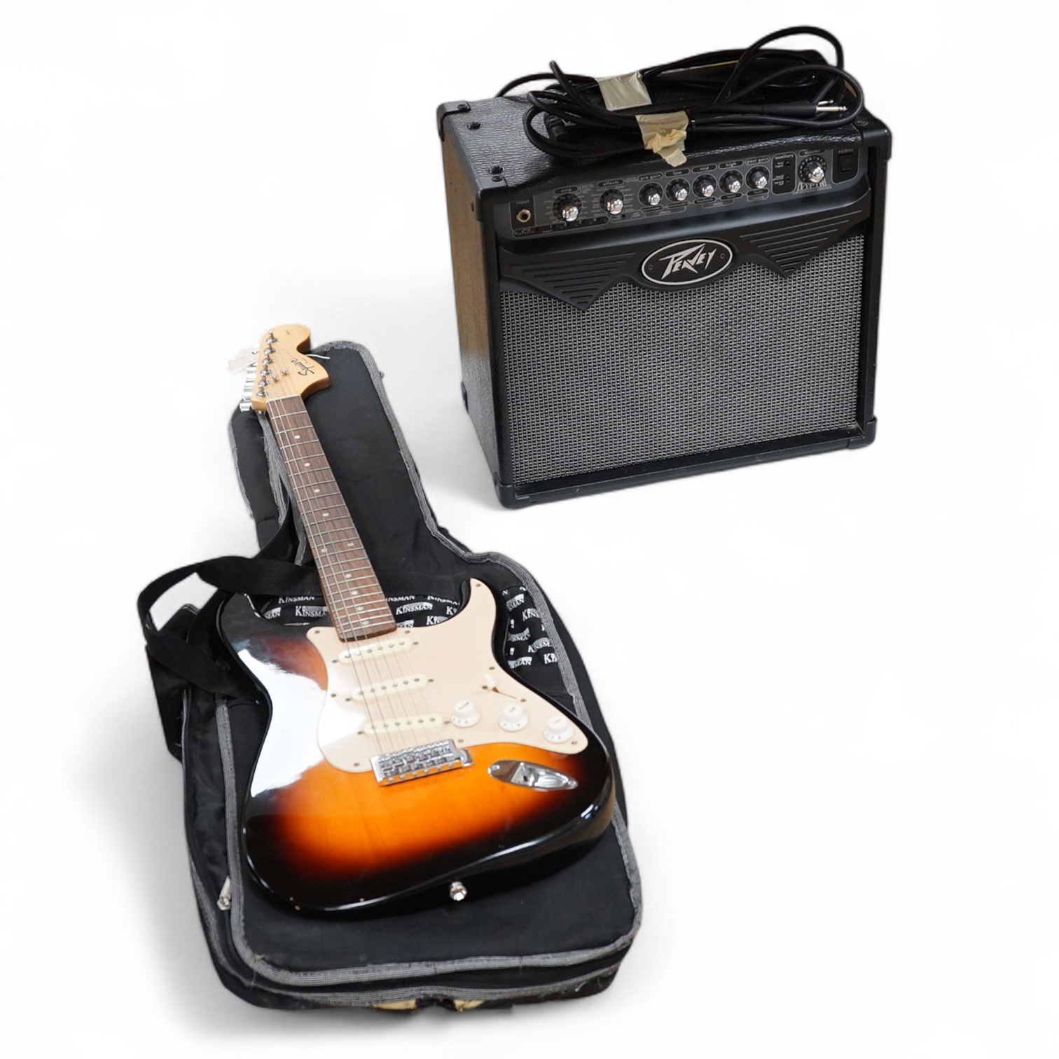 A Fender Squire electric guitar, with a Kinsman soft case, together with a Peavey VYPYR 15W modelling amplifier